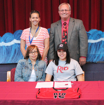 Lake Ridge Academy's Sharday Baines poses with her mother and coaches after signing with Rio Grande